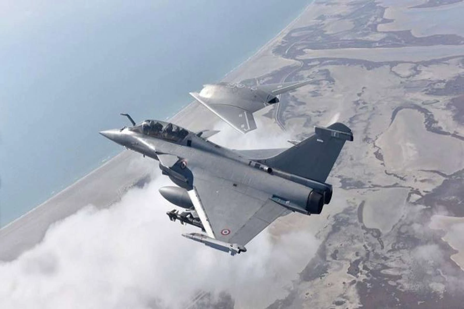 Macron visits India to discuss $35 billion jet deal